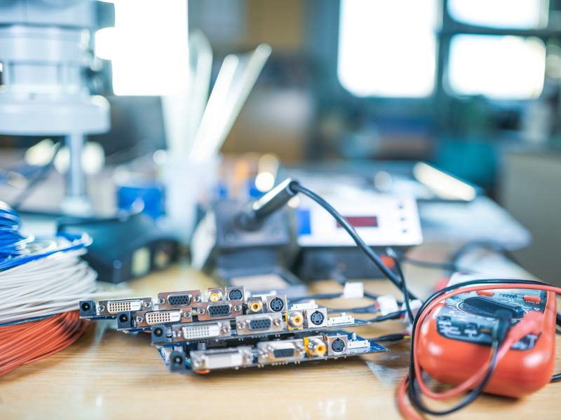 Large modern electron microscope and embedded microcircuits are stacked on test plate to prepare for the research of electronic components in a scientific laboratory