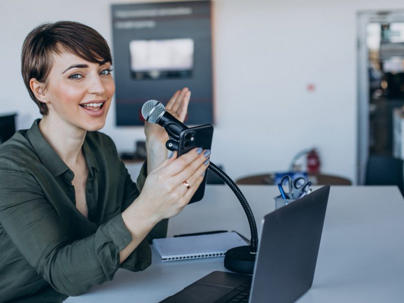 Young woman vlogger recording at studio